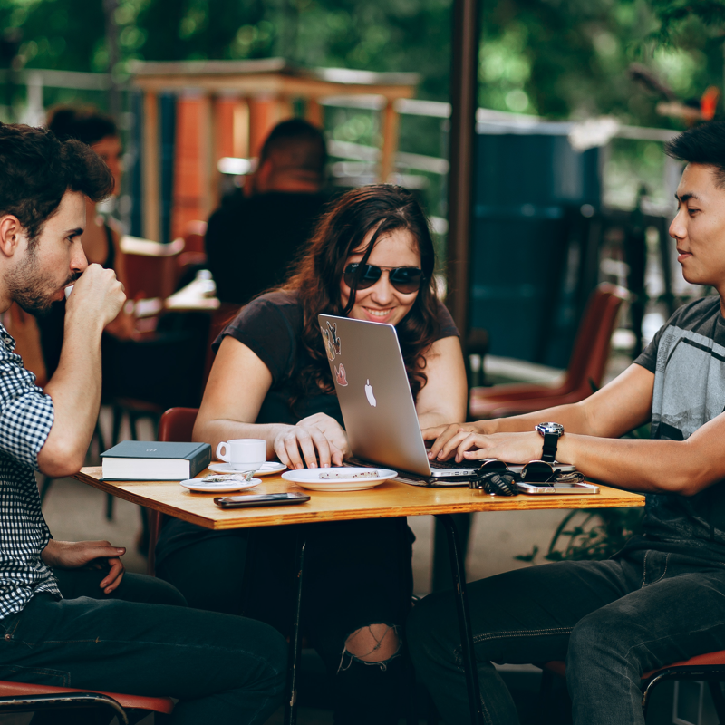 people working in outdoor cafe